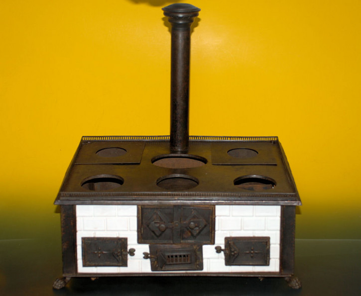 antique children stove with stoneware glazed tiles at 1870-1880