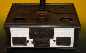 antique children stove with stoneware glazed tiles at 1870-1880