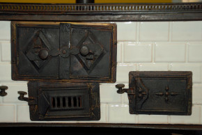 antique children stove with stoneware glazed tiles at 1870-1880