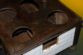 antique children stove with stoneware glazed tiles at 1870-1880