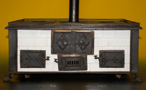 antique children stove with stoneware glazed tiles at 1870-1880