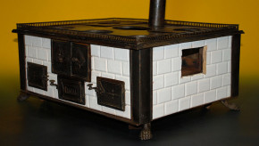 antique children stove with stoneware glazed tiles at 1870-1880