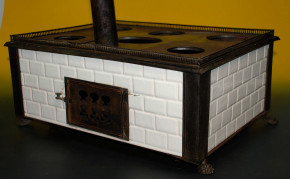 antique children stove with stoneware glazed tiles at 1870-1880