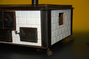 antique children stove with stoneware glazed tiles at 1870-1880